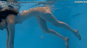 Marfa, the Russian babe, flaunts her narrow ass and pussy in the pool